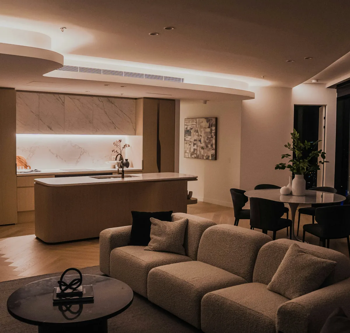 Modern apartment living room and kitchen at dusk