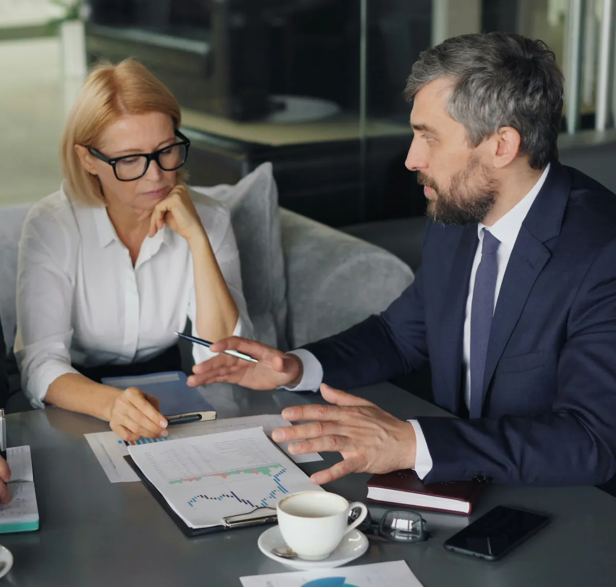 Consultant going over a report with two clients